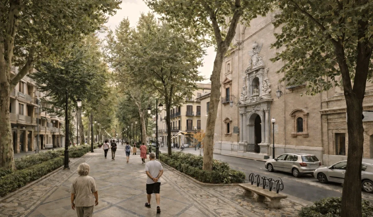Ruta del Realejo en Granada con paseo arbolado, iglesia barroca a la derecha y baldosas geométricas en el suelo, ambiente urbano con luz natural y contraste moderado