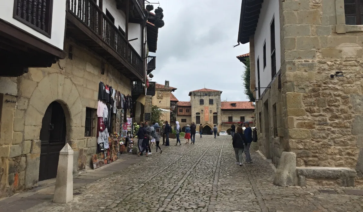 Calle Juan Infante en Santillana del Mar Cantabria con tiendas, turistas y arquitectura medieval en casco histórico
